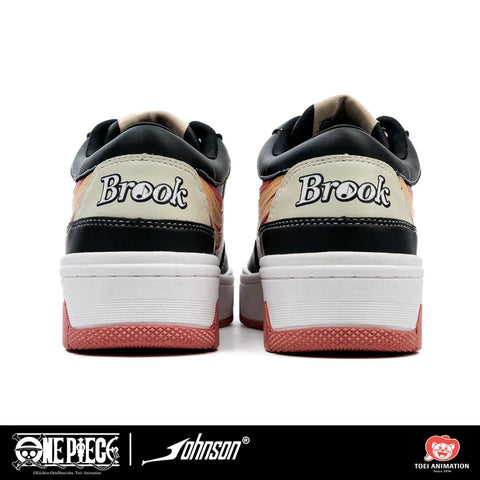 One Piece Brook sneaker front three-quarter view in black white and peach